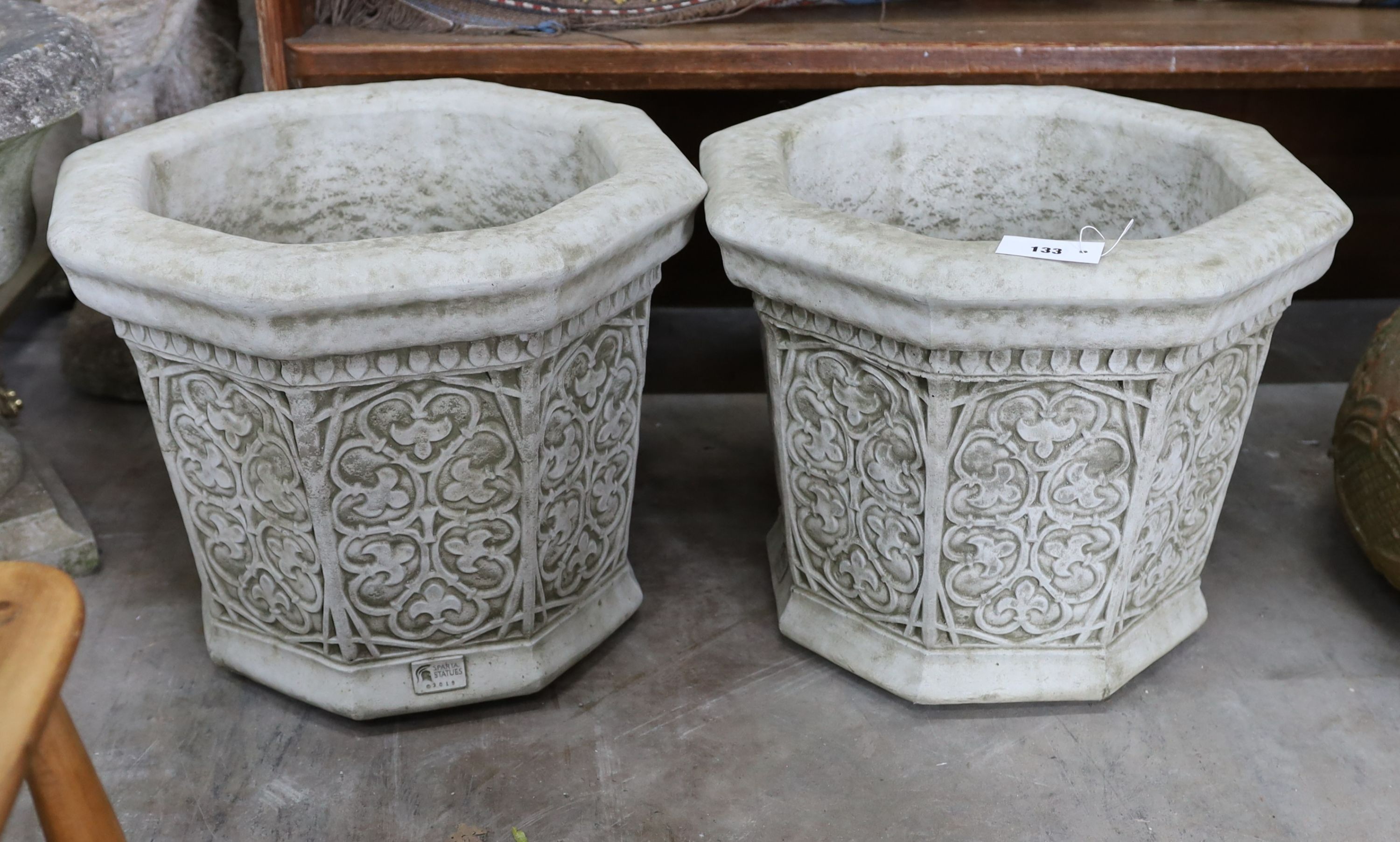 A pair of octagonal reconstituted stone garden planters, width 49cm, height 41cm